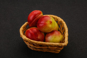 Fototapeta na wymiar Sweet small nectarines in the basket