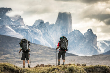 Rear view of backpackers hiking in Akshayak Pass, Baffin Island