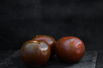 Tomatoes Kumato  on the table