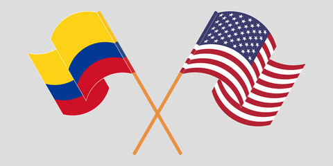 Crossed and waving flags of Colombia and the USA