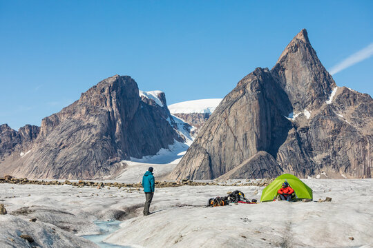 Climbers relaxing at basecamp on glacier below Mt. Loki, Baffin Island
