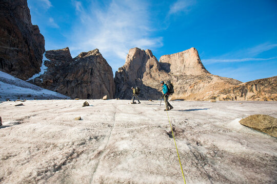 Roped climbing team approach Mount Asgard, Baffin Island.