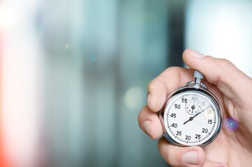 Silver classic stopwatch in the human hand