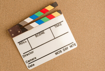 vacation, travel and summer vacation concept: movie clapperboard on the beach sand