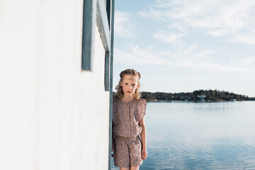 portrait of a young girl playing on her own at the beach