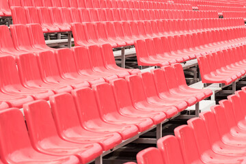 Fototapeta premium Rows of empty red grandstand seats, selective focus