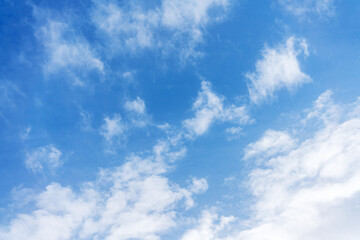 .White cumulus clouds against the background against blue on a blue background.