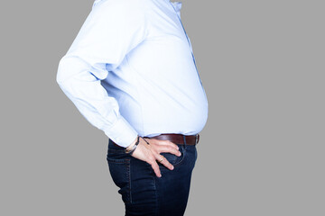 man with a big belly and overweight is wearing  a shirt and jeans