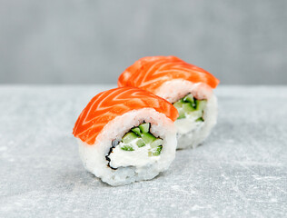 2 slices of semi-classic Philadelphia sushi with salmon and cucumber