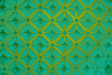 Fototapeta premium Golden pearls on a teal and green net pattern