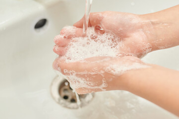 Fototapeta premium washing hands with soap under the tap. There is no pandemic.