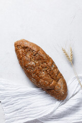 Homemade crusty loave of wholemeal bread on white background