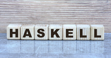 concept word HASKELL on wooden cubes on a beautiful gray background