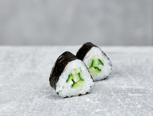 two slices of mini sushi roll maki with cucumber