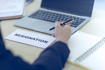 An employee resignation letter is placed on the personnel manager's desk in the office.