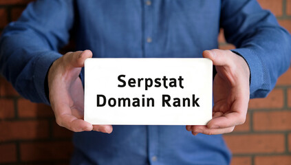 Domain rank - seo concept in the hands of a young man in a blue shirt