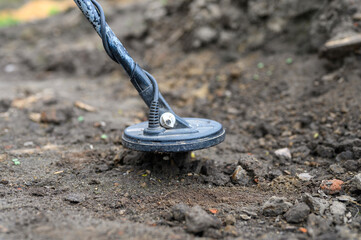 coil electronic metal detector device for search a treasure on ground background