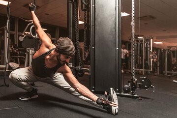 A bearded sporty man in the gym is doing Yoga and Martial Arts exercises. Yoga mental benefits.