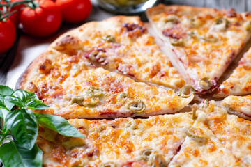 Tasty pizza. Italian pizza with tomato, mozzarella cheese, olives on a wooden table