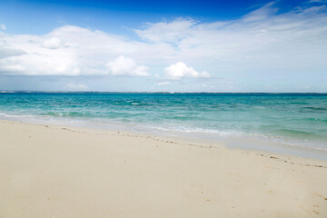 Fototapeta na wymiar Clean white sand beach with turquoise water . Tropical island background. Small waves crushing on the beach. Clean empty white sand beach on Maldives island 