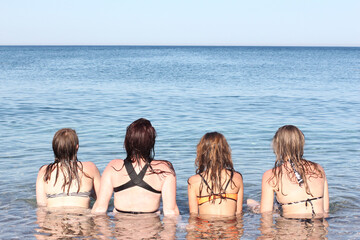 4 girls in bikini relaxing on seaside. Vcation photos.