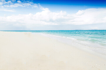 Clean white sand beach with turquoise water . Tropical island background. Small waves crushing on the beach. Clean empty white sand beach on Zanzibar. Paradise beach