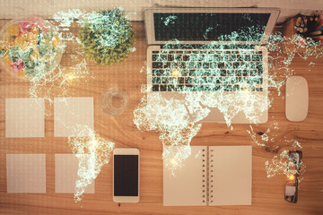 Social network hologram drawings over computer on the desktop background. Top view. Double exposure.