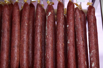 Factory for the production of meat products, cured sausages. Traditional spicy sausage hanging to dry, covered with fungus. Concept of handmade meat products. Delicacy. 