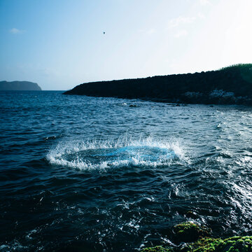Circular splash in ocean from fishing net