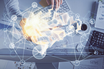 Double exposure of man's hands typing over computer keyboard and brain hologram drawing. Top view. Ai and data technology concept.