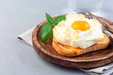 Trendy cloud or fluffy egg dish on  wooden plate, horizontal, copy space