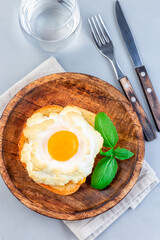 Oven baked cloud or fluffy egg dish on a wooden plate, vertical, top view