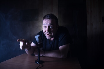 Serious reporter in television studio looking at the camera