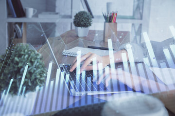 Double exposure of woman hands typing on computer and forex chart hologram drawing. Stock market invest concept.