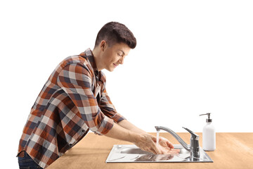 Profile shot of a guy washing hands