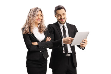 Fototapeta na wymiar Professional man in a black suit showing something on a tablet to a businesswoman