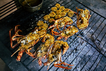 Freshly caught lobster grilling on open fire with butter and garlic