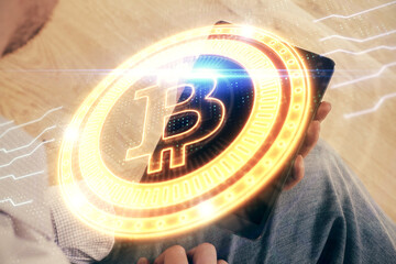 Double exposure of man's hands holding and using a phone and crypto currency blockchain theme drawing.