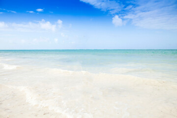Fototapeta na wymiar Clean white sand beach with turquoise water . Tropical island background. Relaxing on empty beach. 