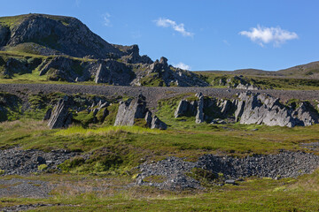 Fototapeta na wymiar Granite rocks and vast tundra on the blue sky background in Northern Finnmark region, Norway