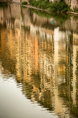 Fototapeta na wymiar Reflections of buildings along the Arno river