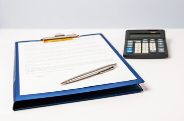 A form for signing on a blue folder with a clip with a pen and a calculator on a light background.