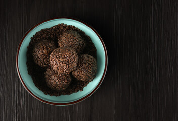Brigadeiro - traditional Brazilian delicacy made from condensed milk, cocoa powder, butter and chocolate sprinkles. Granulated chocolate candy in top view