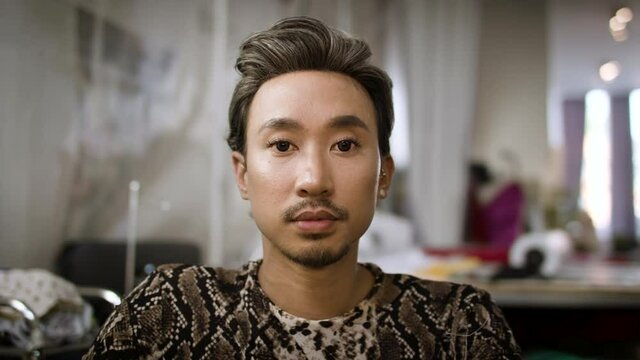 Stylish fashion designer portrait. Handsome and authentic creative portrait. Asian man shot in slow-motion and in 4k. 
