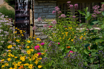 Waterwheel and wildflowers on sunny day