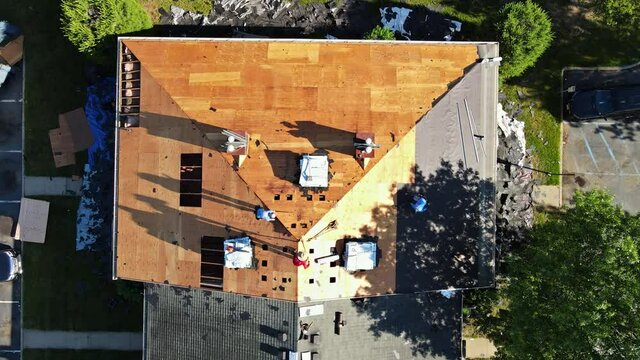 East Brunswick NJ US. 20 JUNE 2020: Removal of old roof and replacement with new roof shingle being applied home roof construction site all a new materials