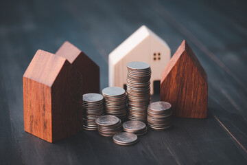 Investment in the real estate business. Money coin stack growing graph and wood house model. Loans...