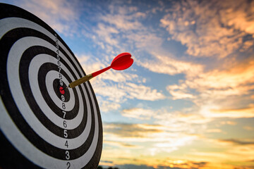 business marketing as concept. Red dart arrow hitting in the target center of dartboard Target hit...