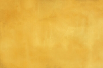 Rustic yellow gold concrete cement wall with darker and lighter areas to use as a background or...