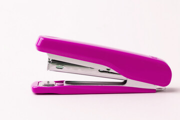 Pink stapler on a white background.